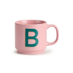 a pink coffee mug with the letter b on it's front and bottom half