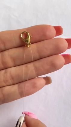 a person is holding an object and threading it with a needle in their hand