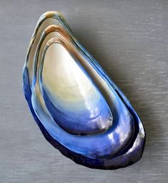 three blue and white vases sitting on top of a gray countertop next to each other