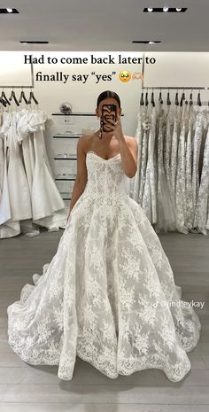 a woman is taking a selfie in her wedding dress