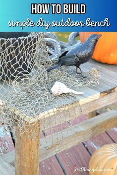 two black birds sitting on top of a wooden table next to a netted basket