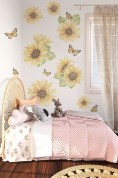 a child's bedroom with sunflowers and butterflies on the wall