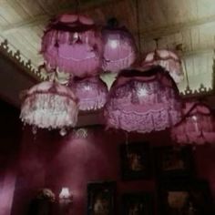 some pink lights hanging from the ceiling in a room