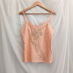 "Richard Malcolm linen peach pink tank top. Has a side zipper and adjustable straps. The front is embroidered and beaded in gold and silver.  Flat Lay Measurements: 17.5\" bust, 16\" waist, 18\" hem, 23\" long" Spring Apricot Sleeveless Tank Top, Apricot Sleeveless Tank Top For Spring, Fitted Embellished Embroidered Top For Summer, Peach Fitted Sleeveless Tank Top, Fitted Peach Sleeveless Tank Top, Fitted Sleeveless Peach Tank Top, Summer Embroidered Gold Tops, Spring Embroidered Spaghetti Strap Tank Top, Embellished Embroidered Top For Summer