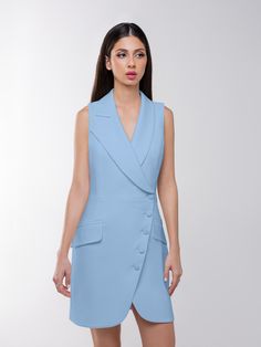 This blazer mini dress offers a chic take on power dressing with its structured cut that delivers timeless elegance, while its asymmetric lapels and double-breasted button closure add a contemporary touch.  The design is cinched at the waist and detailed with flap pockets to create an elegant, structured silhouette. Mindfully made from a luxurious stretch crêpe fabric, it is fully lined with silky satin for a smooth glide.  It is a sartorial chameleon, perfect for those who love their fashion wi Spring Mini Dress With Structured Shoulders For Work, Spring Workwear Mini Dress With Structured Shoulders, Formal Mini Dress With Hidden Button Closure, Chic Tailored Mini Dress, Chic Tailored Mini Dress For Cocktail, Spring Tailored Blazer Dress With Structured Shoulders, Chic Mini-length Blazer Dress For Semi-formal Occasions, Chic Mini Length Blazer Dress For Semi-formal Occasions, Chic Semi-formal Mini Blazer Dress