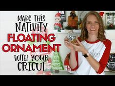 a woman holding a glass ball in front of a shelf with christmas decorations on it