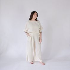 This is loungewear without limits. Comfortable and classy - this one-sized boat top is ideal for those looking to feel luxurious at home, on the town, with glam or on the go. Made with a luxe fabric composed of doubled Turkish muslin cotton. The crinkle muslin texture is incredibly soft on the skin, and feels lightweight, yet substantial when worn. Designed in an oversized style, the Crinkle Crop Top has half sleeves, with a cropped cut at the waist, and a boat neckline. Available in two color s Cream Linen Tops For Loungewear, Cream Linen Loungewear Tops, Relaxed Cream Tops For Loungewear, Relaxed Cream Top For Loungewear, Cream Tops For Spring Lounging, Cream Tops For Lounging In Spring, Beige Cotton Top For Lounging, Beige Cotton Lounging Top, Off White Cotton Tops For Loungewear