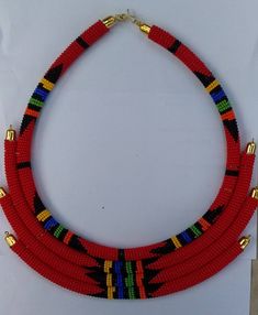 This is a layered African necklace. It totally handmade using fine beads. Elegantly beautiful. Traditional Handmade Double Strand Beaded Necklaces, Traditional Handmade Double Strand Beaded Necklace, Unique Red Multi-strand Beaded Necklaces, Unique Red Multi-strand Beaded Necklace, Unique Tiny Beads Choker Necklace, Unique Handmade Double Strand Necklaces, Handmade Layered Necklace With Round Beads For Gifts, Unique Multi-strand Beaded Necklace, Unique Multi-strand Beaded Chain Necklace