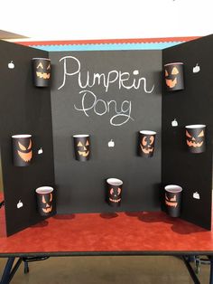 there is a display with cups and pumpkins on it