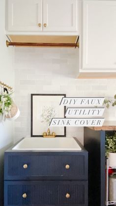 a blue dresser in a kitchen with white cabinets