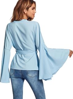 This Belted Wrap Style Bell Sleeve Top is the perfect combination of style and comfort. Made from lightweight yet durable fabric, this top features statement bell sleeves and a flattering wrap style, complete with a waist belt. Effortlessly stylish and comfortable enough for all-day wear. 95% Polyester, 5% Spandex Imported Pull On closure Hand wash or machine wash. Do not bleach. V neck bell sleeve tie waist wrap surplice blouse tops, ruched front, plain, premium fabric for comfortable to wear. Surplice Blouse, Winter Knit Hats, Blouse Tops, Medium Dress, Large Dress, Boot Accessories, Small Dress, Winter Knits, Premium Fabric