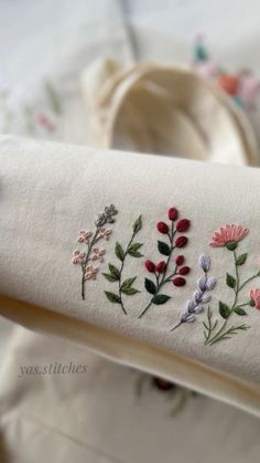 embroidered flowers and leaves on a white cloth