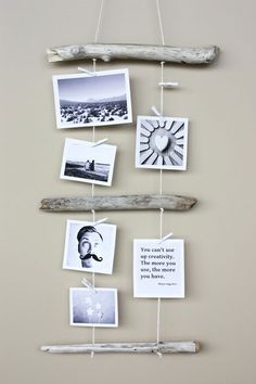 some pictures are hanging on a wall and there is a driftwood stick attached to it