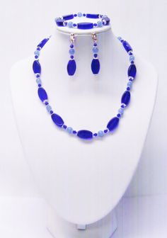 "Royal Blue Elliptical Glass Bead Choker Necklace/Bracelet/Earrings Set This necklace set is made 19x8mm navy blue elliptical glass beads, 6mm light blue glass beads, navy blue Bicone glass, silver plated bead caps and silver plated spacer beads strung on flexible beading wire. It is 17\" (plus 2\" extension chain) in length and it fastens with silver plated lobster clasp. It comes with bracelet and earrings that dangle from silver plated fish hook ear wires. Necklace Length: 17\" (plus 2\" exte Bead Choker Necklace, Bead Choker, Beading Wire, Beaded Choker Necklace, Wire Bracelet, Bead Stringing, Beaded Choker, Bead Caps, Chain Earrings