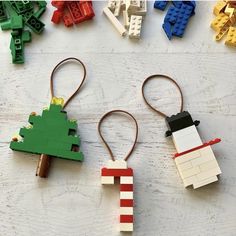 three lego keychains made to look like christmas trees