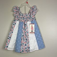 New With Tags Penelope Mack Red White Blue Floral Dress. Comprised Of Different Fabrics. Sleeveless. Smocked At Chest And Lined. Size 18 Months Patriotic And Perfect For The Fourth Of July! 100% Cotton Lining 80% Cotton 20% Poly Smoke Free Home Thank You So Much For Visiting My Closet! Bundle And Save! I Love Offers! Please Keep In Mind That Poshmark Takes A Flat Fee Of $2.95 On All Orders Under $15. For Orders Over $15, Poshmark Takes A 20% Commission. Shop With Confidence. I Have A 5 Seller Ra Playful Sleeveless Holiday Dress, Casual White Sundress For Dress-up, Multicolor Cotton Holiday Dress, Holiday Multicolor Cotton Dress, Multicolor Cotton Dress For Holiday, Blue Ruffled Dress For Holiday, Holiday Blue Ruffled Dress, Blue Holiday Dress With Ruffles, Blue Holiday Dresses With Ruffles