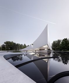 the building is designed to look like a triangular structure with its reflection in the water