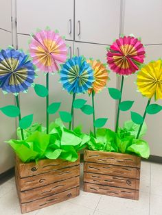 two wooden boxes with paper flowers in them