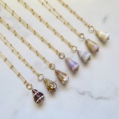 "Hawaiian Cone Shell Necklaces~ Dainty Hawaiian shell necklaces, choose shell from the drop down menu. Great gift for the beach lover! Made with 14k gold fill Chain 18\" Ring and shell dangle approx. 1\" Shop~ http://www.etsy.com/shop/HanaMauiCreations?ref=pr_shop_more International buyers please read our shipping policies before ordering~ POLICIES~ https://www.etsy.com/shop/HanaMauiCreations/policy?ref=shopinfo_policies_leftnav" Cone Shell Jewelry, Beach Shell Charm Necklaces With Lobster Clasp, Beach Charm Necklaces With Shell And Lobster Clasp, Beach Charm Necklaces With Lobster Clasp And Shell Material, Shell Charm Necklaces With Lobster Clasp For Beach, Handmade Shell Charm Necklaces For Beach, Handmade Shell Charm Necklace For Beach, Hawaiian Shell Jewelry, Bohemian Teardrop Necklace For Beach