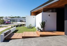 a house with wooden steps leading up to the front door and side yard area on either side