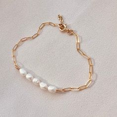 The Vive Bracelet~  Vive is the Latin word for "live." May this bracelet be a little reminder to stay positive, and live in the moment.  This listing is for one pearl bracelet. It's perfect on its own, or stacked with other In Situ bracelets as shown.  - 14k gold filled chain  - Natural, freshwater pearl  - Goes well with the ALEXANDRA pearl necklace  - Nickel free and suitable for sensitive skin  Sized by circumference: XS: 6"  S: 6.5"  M: 7" L: 7.5"  XL: 8" *This bracelet comes with a 0.5" ext Minimalist Everyday Pearl Bracelet With Adjustable Chain, Everyday Minimalist Pearl Bracelet With Adjustable Chain, White Minimalist Charm Bracelet, Minimalist Pearl Bracelet With Extender, Everyday Minimalist Pearl Bracelet With Extender, Dainty Pearl Charm Bracelets For Everyday, Minimalist Everyday Bracelet With Pearl Charm, Dainty Pearl Charm Bracelet For Everyday Wear, Dainty Everyday Bracelets With Pearl Charm