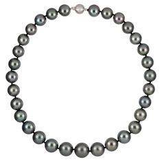 A graduated silver/grey Tahitian pearl necklace, the pearls graduating from 15.5mm to 12mm from the centre, double knotted and fitted with a matte white gold ball clasp set with eight round brilliant cut diamonds of 0.04 carats in total, bearing the convention marks of 18ct gold, London, measuring approximately 42.5cm in length and 31 pearls in total, gross weight 103.1 grams. A Tahitian pearl necklace in very good condition. This superb grey Tahitian pearl necklace comes from the collection of Grey Pearl Necklace, Tahitian Pearl Necklace, Jewel Necklace, Vintage Jewelry Necklace, Cultured Pearl Necklace, Tahitian Pearls, Vintage Jewels, Pearl Grey, Tahiti