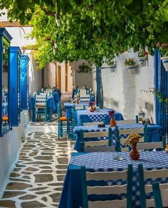 an outdoor dining area with blue and white tables