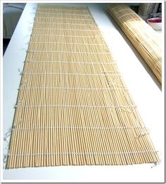 a bamboo mat sitting on top of a white table next to a window sill