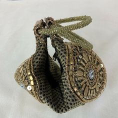 Rare! Folded Handmade India-Gold Sequin Beads/Rhinestones/Wristlet/Purse/Bag. Awesome condition! Please see photos for condition and size. No rips or stains.This wonderful has gold tone beaded bangle handles Shipped with USPS First Class. Beaded Potli Bag Pouch For Gifts, Beaded Potli Bag Gift, Beaded Potli Bag Gift Pouch, Beaded Pouch Potli Bag As Gift, Beaded Pouch Potli Bag For Gift, Bohemian Beaded Potli Bag For Gifts, Bohemian Beaded Potli Bag As Gift, Traditional Beaded Pouch Clutch, Handheld Beaded Clutch