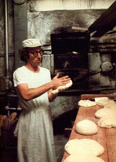 a woman in an old fashioned kitchen making bread