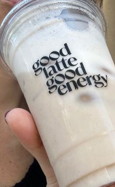 a person holding up a drink with the words good state good energy written on it