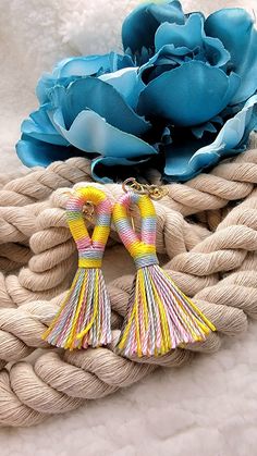 "✨️FREE SHIPPING (USPS First-Class Mail) and will ship out in ONE Business Day ✨️ \"Vibrant Striped Tassel Earrings: A Spring/Summer Symphony of Color\" Step into the bright side of fashion with our Vibrant Striped Tassel Earrings, tailored perfectly for the Spring and Summer seasons. Swirling in a harmonious yellow, blue, and pink blend, each tassel tells a story of vibrant sunsets, clear blue skies, and blooming flowers. Handcrafted with precision, these earrings exhibit the elegance of simpli Multicolor Beaded Tassel Earrings For Beach, Multicolor Beach Earrings For Spring, Multicolor Fun Earrings For Vacation, Fun Multicolor Earrings For Vacation, Spring Beach Multicolor Earrings, Multicolor Tassel Earrings For Beach, Handmade Dangle Tassel Earrings For Beach, Bohemian Multicolor Tassel Earrings For Beach, Handmade Multicolor Tassel Earrings For Beach