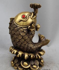 a gold colored figurine sitting on top of a table