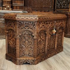 an ornate wooden box is on display in a room filled with books and other items