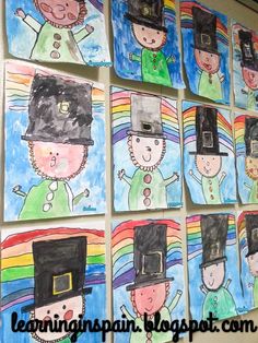 children's art work on the wall with pictures of people in hats and rainbows