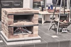 a brick oven sitting on top of a tiled floor