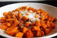 a white bowl filled with food on top of a table