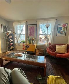 a living room filled with furniture and lots of windows