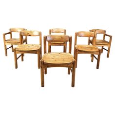 six wooden chairs and one stool are shown