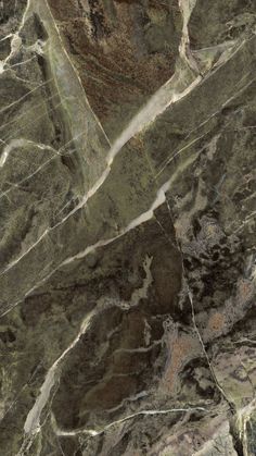 an aerial view of a mountain range with brown and green marble on the sides,