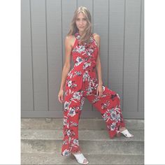 Truth + Wisdom Ruffle V-Neck Flowered Red Jumpsuit Chic Red Jumpsuits And Rompers For Summer, Chic Red Jumpsuits And Rompers For Vacation, Casual Red V-neck Jumpsuits And Rompers, Casual Red V-neck Jumpsuit, Red V-neck Jumpsuits And Rompers For Spring, Red Jumpsuits And Rompers For Summer Day Out, Red V-neck Jumpsuit For Spring, Summer Floral Print Red Jumpsuits And Rompers, Red Floral Print Jumpsuits And Rompers For Summer