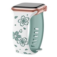 an apple watch with floral designs on the front, and a pink band that is attached to