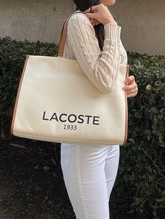 Lacoste Unisex Canvas Tote Natural Tan NU4342TD K02A tote - but a sophisticated tote. Made from an elegant canvas fabric, a nod to Lacoste's iconic tennis style. Result: A generously-proportioned bag that'll hold your essentials in style. Dimensions : L15.7 x H11.6 x D7" / L40 x H29.5 x D18 cm Cotton outer 45 cm / 18" handles 1 zipped inside pocket Large enough to fit your 17" laptop Outside : Cotton (100%) Luxury White Canvas Bag With Canvas Lining, Classic White Canvas Tote Bag, Classic Canvas Shopping Bag With Large Capacity, White Coated Canvas Bag With Dust Bag, White Coated Canvas Tote Bag, White Coated Canvas Bag With Double Handle, Coated Canvas Bag With Dust Bag Included, White Double Handle Coated Canvas Bag, Tan Cotton Bag