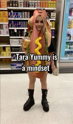 a woman wearing a costume made to look like a hot dog and holding a drink