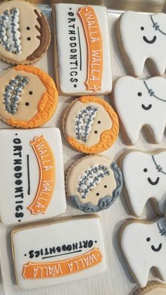 decorated cookies are arranged on a table for someone's dental care day party or celebration