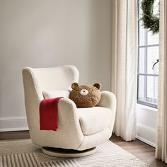 a teddy bear sitting in a white chair