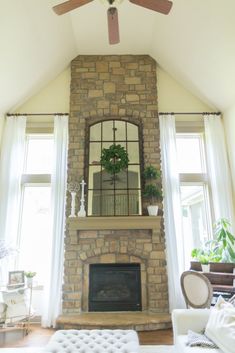 a living room filled with furniture and a fire place in front of a large window