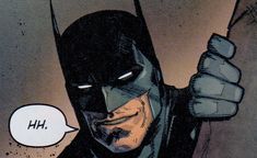 the batman is holding his fist up and pointing at something