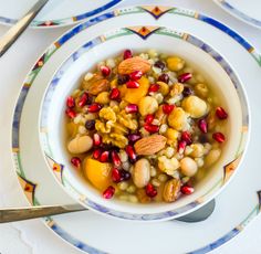 a bowl filled with fruit and nuts on top of a plate