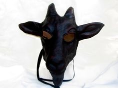 "GOAT MASK IN LEATHER This item is available to order. Please allow three weeks before shipping. Length 17\" (43 cm) Width 15,7\" (40 cm) with ears Width 7,5\" (19 cm) without ears Our masks are made entirely by hand, all in genuine leather and wearable. The masks are designed not only as art objects, but also to be worn. Thanks to our special process the leather retains its elasticity allowing a good fit of the mask. The leather we luse is tanned using vegetable products. The casts of which are Horn Costume, Goat Mask, Horns Costume, Pagan Magic, Mask Shapes, Costume Masks, Animal Masks, Costume Mask, Beautiful Mask